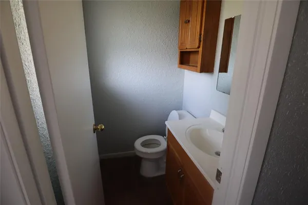 a white toilet sitting next to a sink