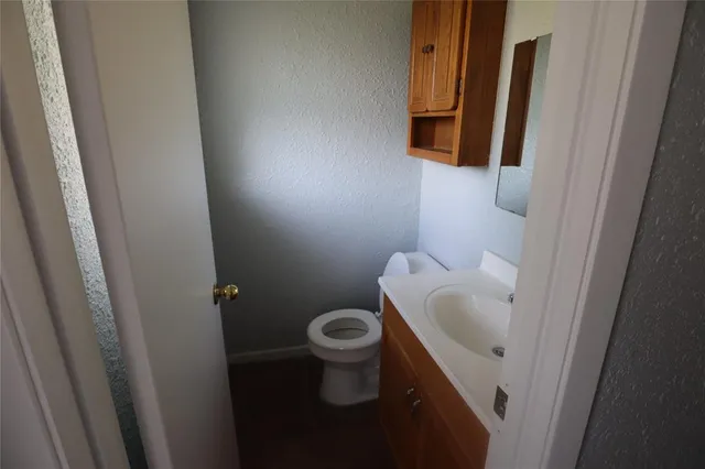 a white toilet sitting next to a sink
