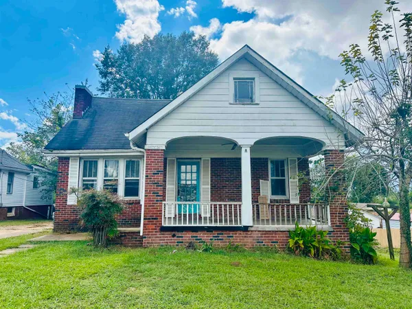 a view of a house with a yard and garden