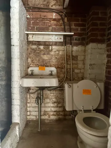 a bathroom with a sink toilet and mirror