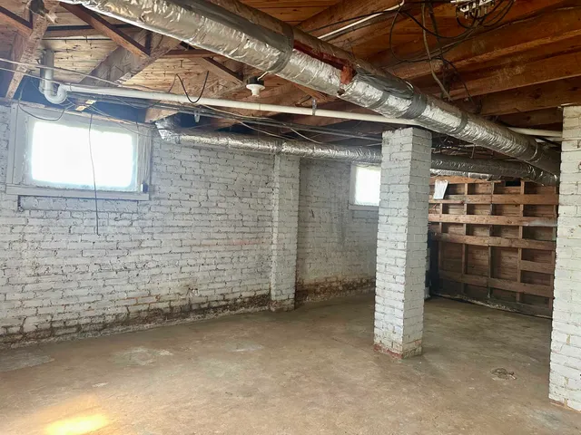 a view of an empty room with a brick wall