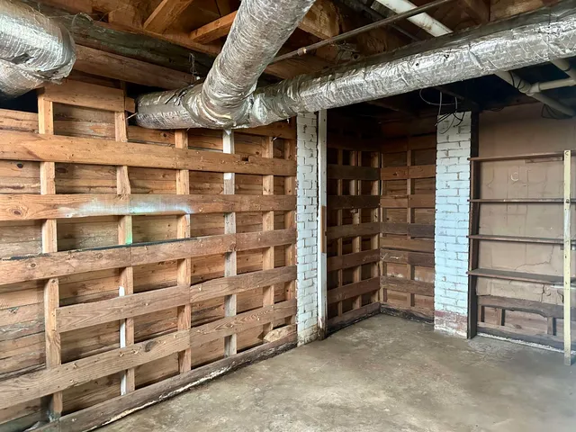 a view of an empty room with a brick wall