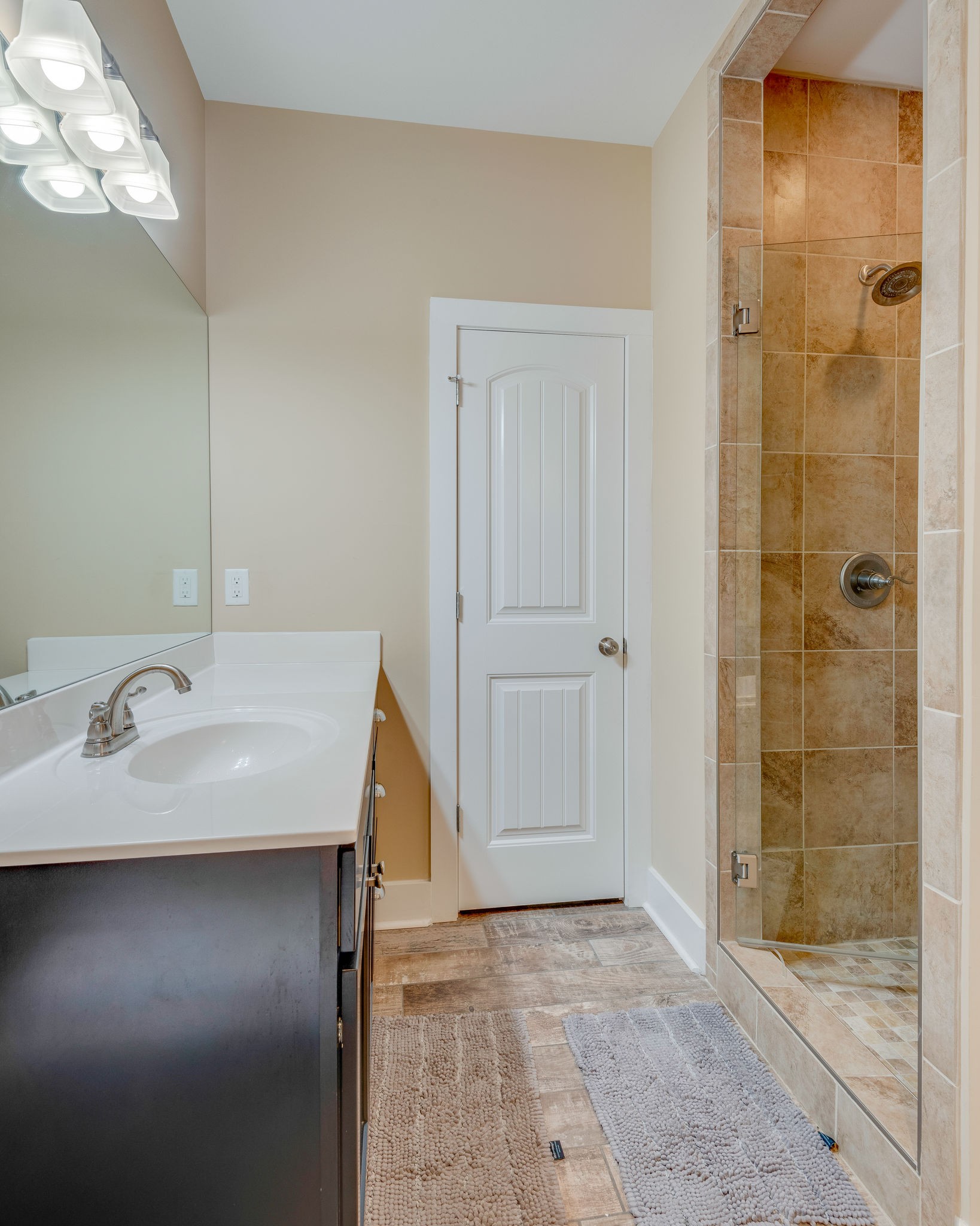 872 Tidwell Road Burns, TN 37029 - Photo 18 of 26 a bathroom with a granite countertop sink a shower and a mirror