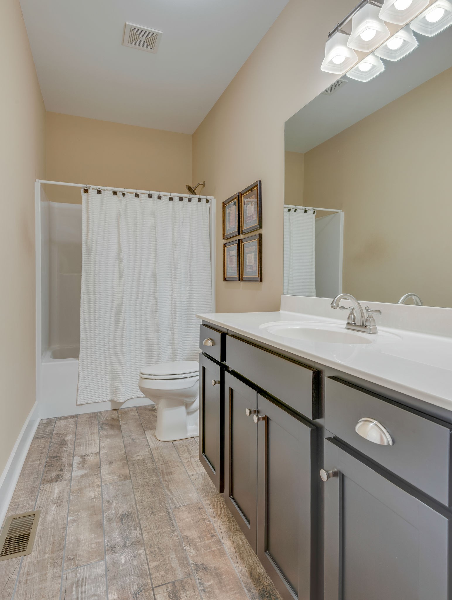 872 Tidwell Road Burns, TN 37029 - Photo 21 of 26 a bathroom with a sink a toilet a mirror a vanity and shower