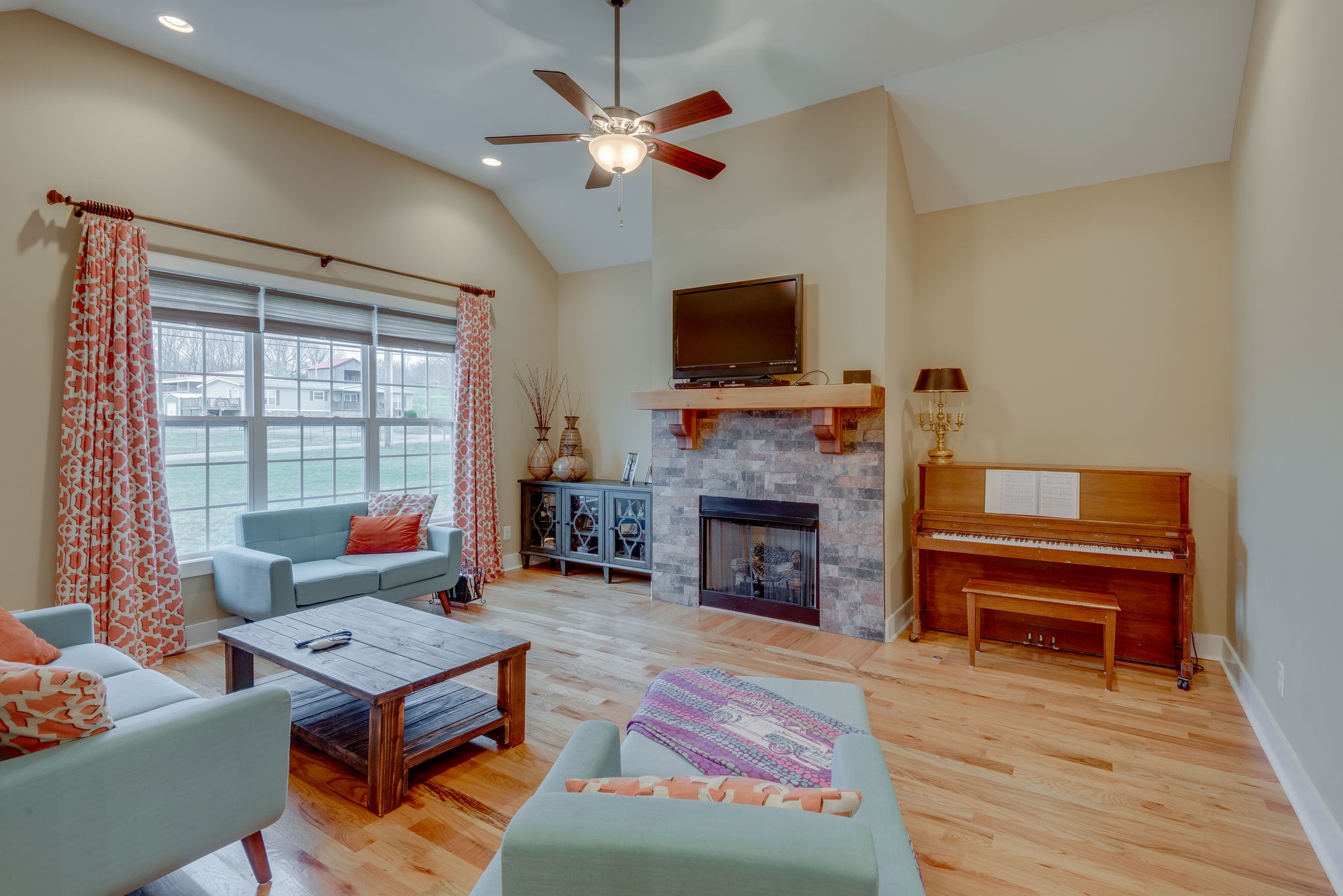 872 Tidwell Road Burns, TN 37029 - Photo 6 of 26 a living room with furniture a fireplace and a flat screen tv