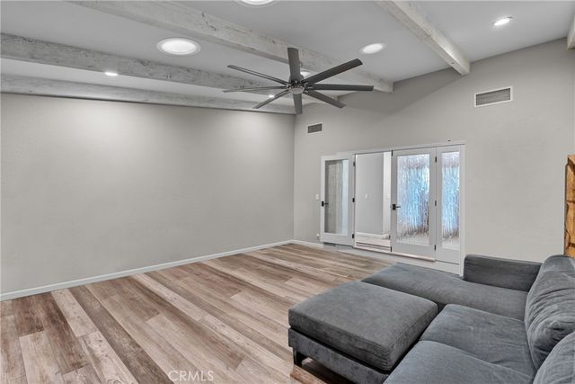 a living room with furniture and a ceiling fan