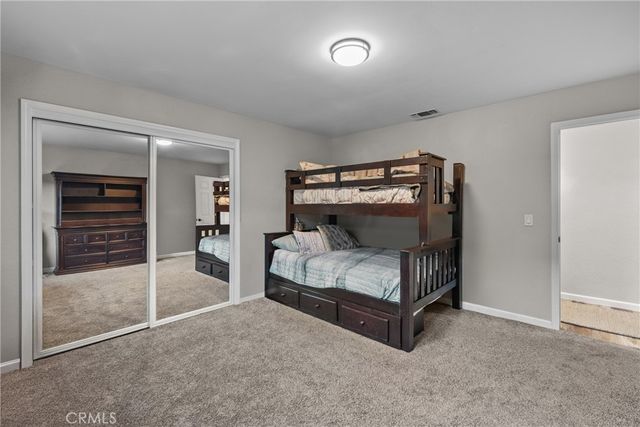 a bedroom with a bed and a lamp