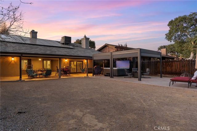 a view of a house with a patio and a yard