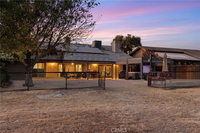 a view of a house with a yard and sitting area