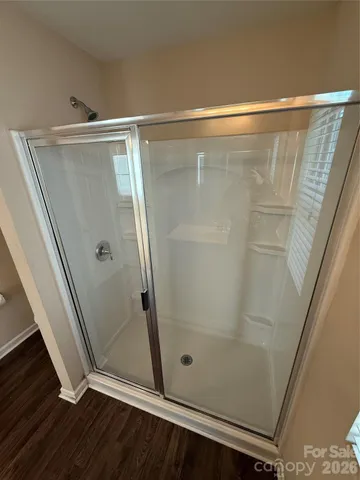 a bathroom with a glass door shower