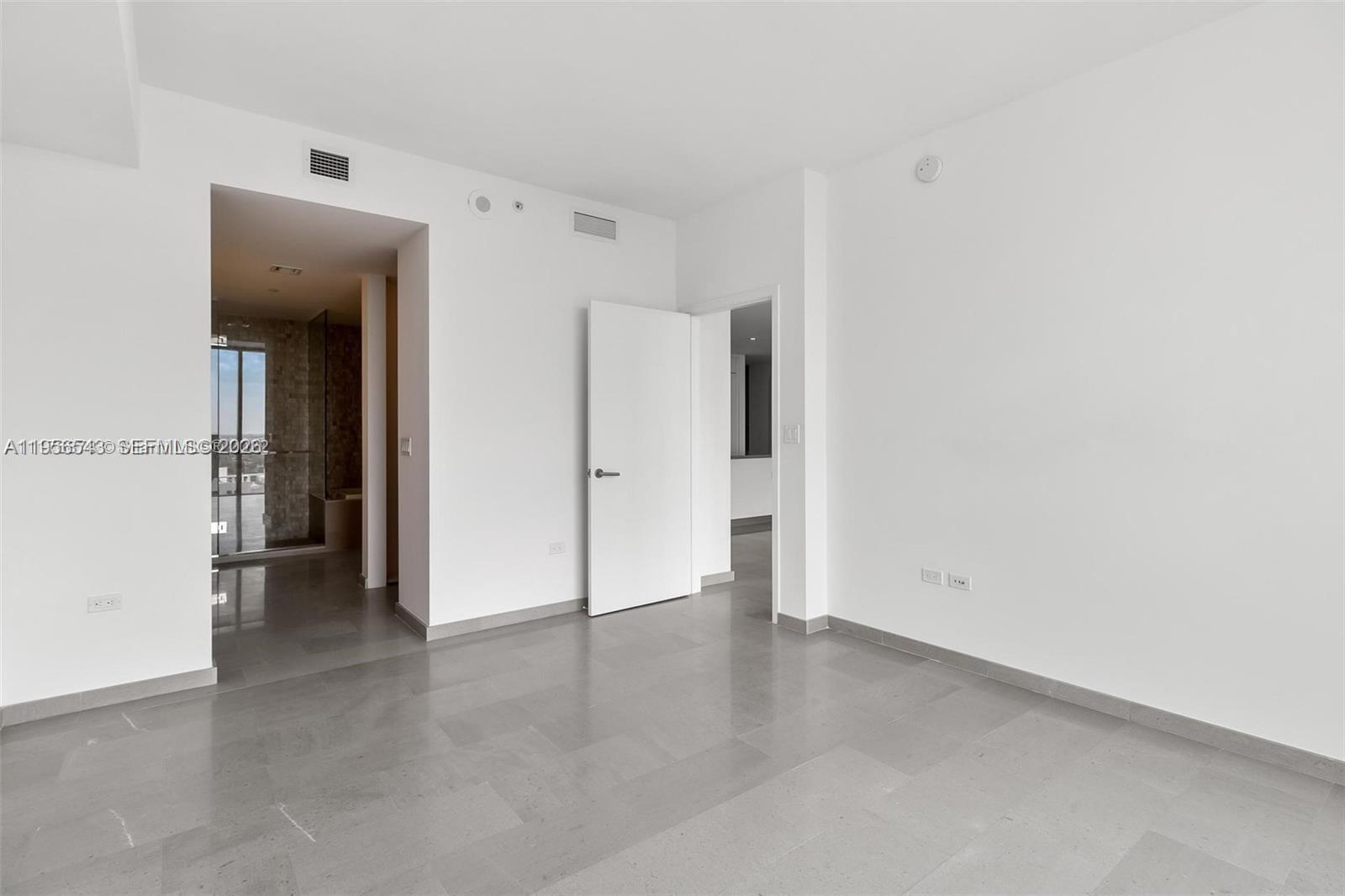 88 Southwest 7th Street, Unit 2104 Miami, FL 33130 - Photo 15 of 50 an empty room with a closet and a hallway