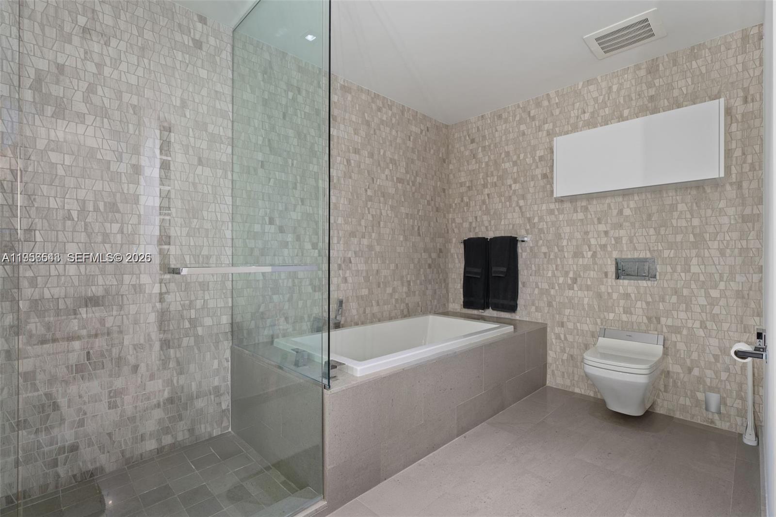 88 Southwest 7th Street, Unit 2104 Miami, FL 33130 - Photo 17 of 50 a bathroom with a toilet a sink and bathtub