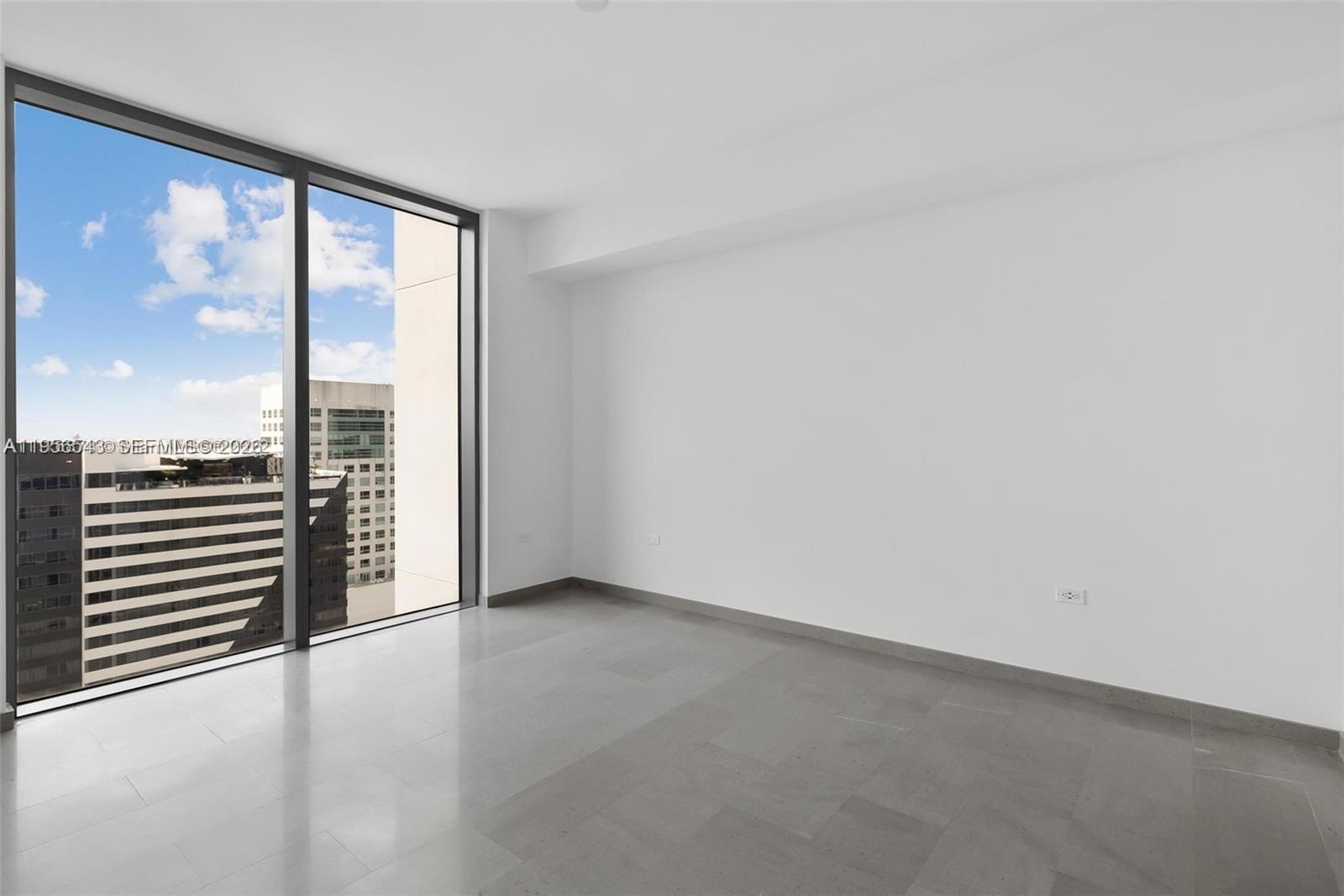 88 Southwest 7th Street, Unit 2104 Miami, FL 33130 - Photo 18 of 50 an empty room with wooden floor and windows