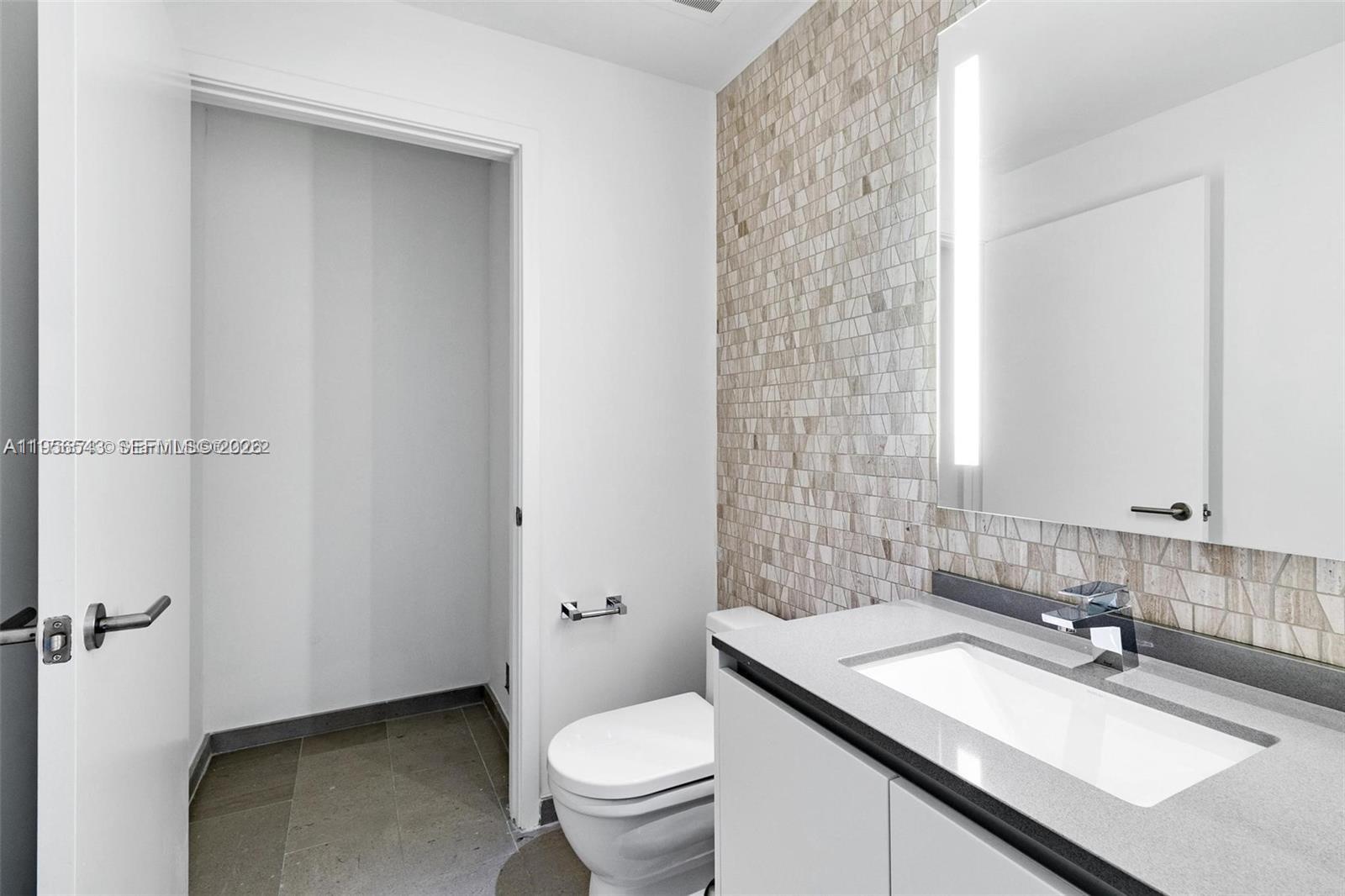 88 Southwest 7th Street, Unit 2104 Miami, FL 33130 - Photo 23 of 50 a bathroom with a sink toilet vanity and shower