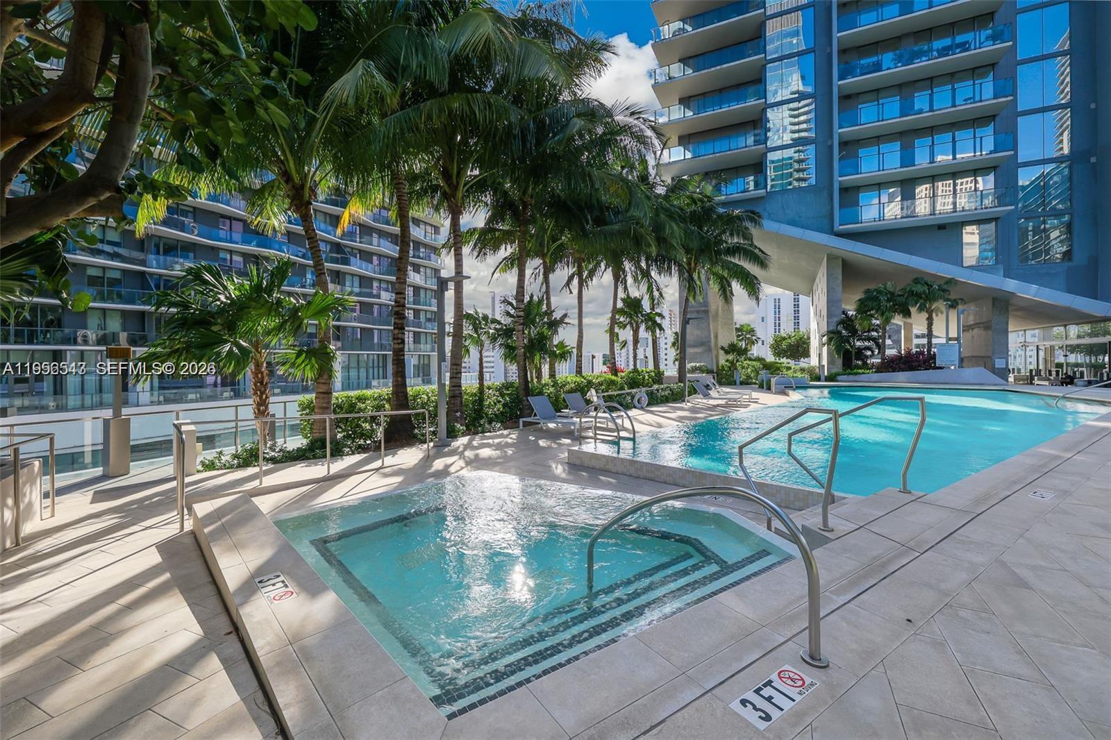 88 Southwest 7th Street, Unit 2104 Miami, FL 33130 - Photo 28 of 50 a view of a swimming pool with a patio