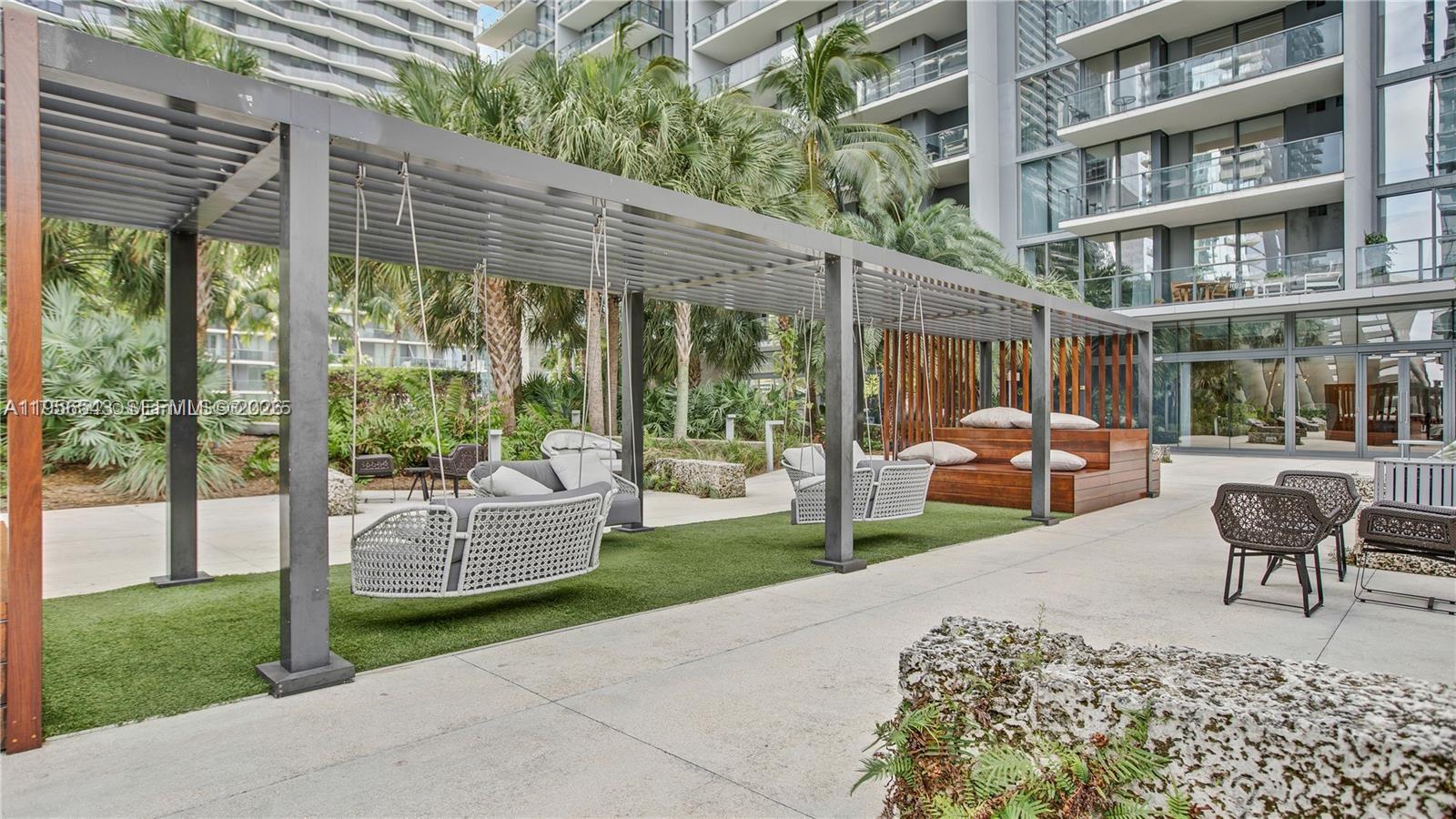 88 Southwest 7th Street, Unit 2104 Miami, FL 33130 - Photo 33 of 50 a building outdoor space with patio couch and glass windows