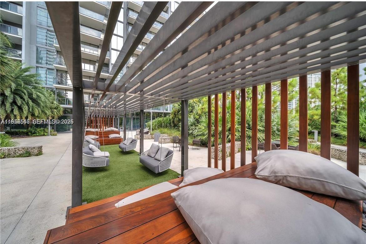 88 Southwest 7th Street, Unit 2104 Miami, FL 33130 - Photo 34 of 50 a bedroom with furniture and large windows