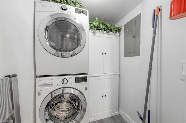 a bathroom with a granite countertop bathtub shower sink vanity mirror and toilet