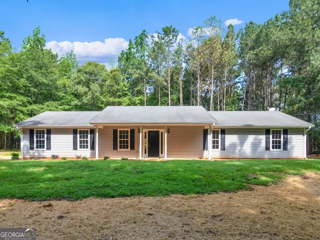 a front view of house with yard and green space