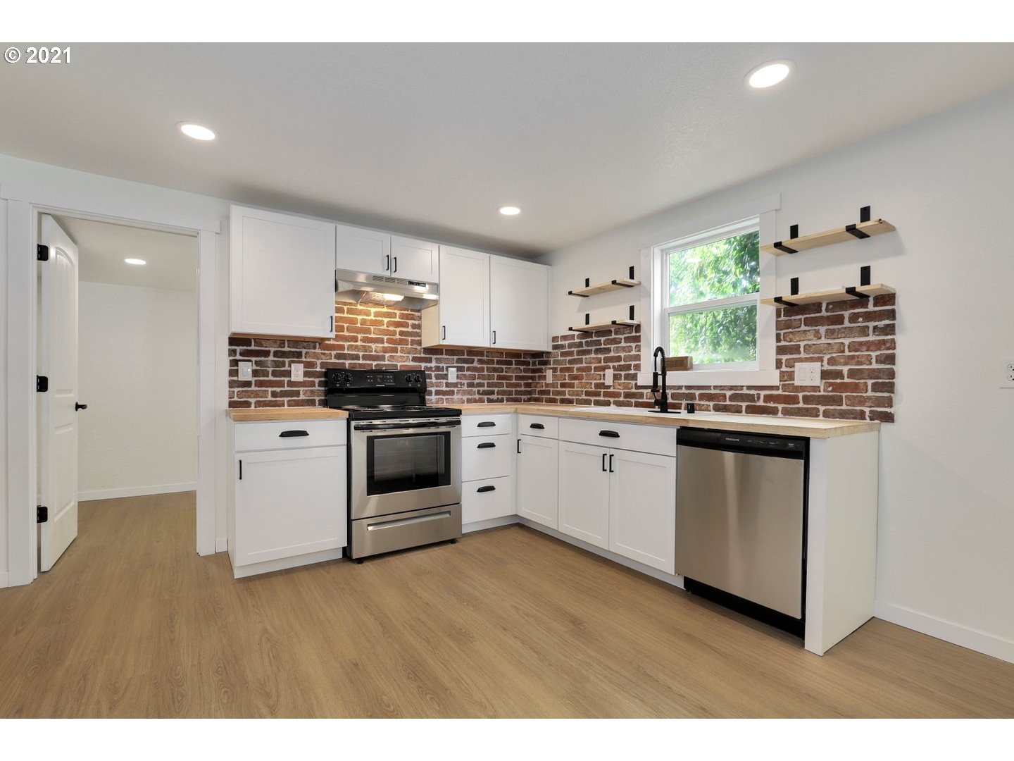 817 Highland Street Ridgefield, WA 98642 - Photo 13 of 27 a kitchen with stainless steel appliances granite countertop a stove a sink and a microwave