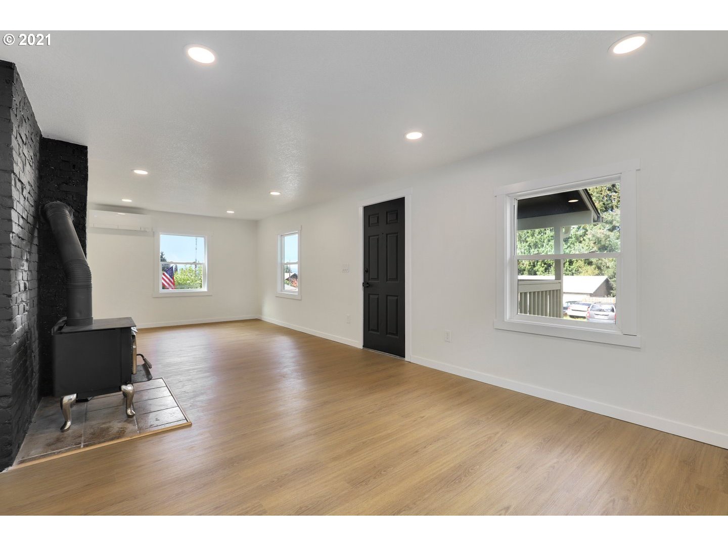 817 Highland Street Ridgefield, WA 98642 - Photo 8 of 27 a view of an empty room with wooden floor and a window
