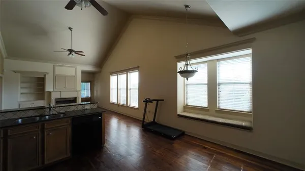 a kitchen with granite countertop a stove a sink and a window