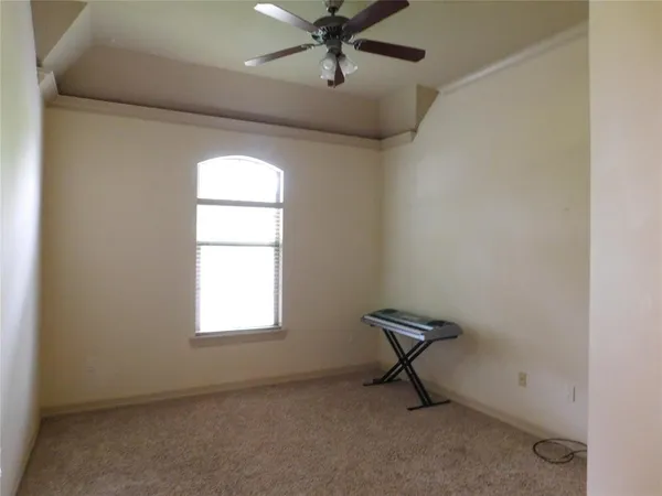 a view of room with window and a ceiling fan