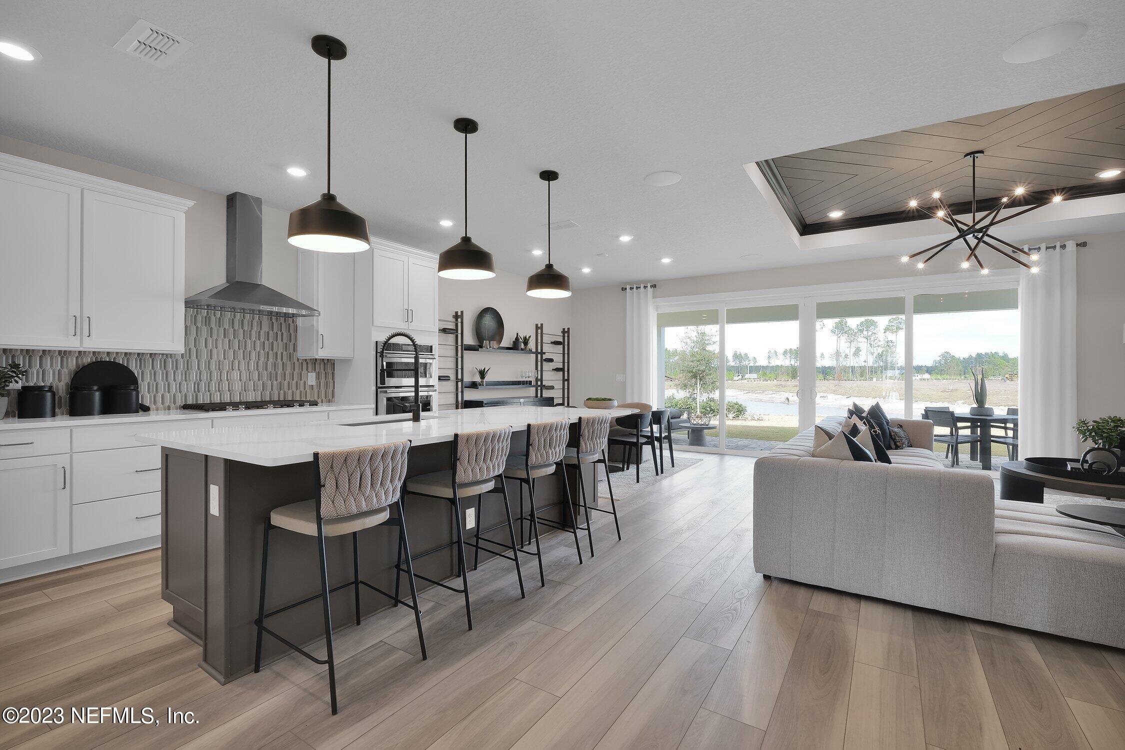 306 Shortleaf Lane Yulee, FL 32097 - Photo 9 of 35 a large kitchen with a table and chairs