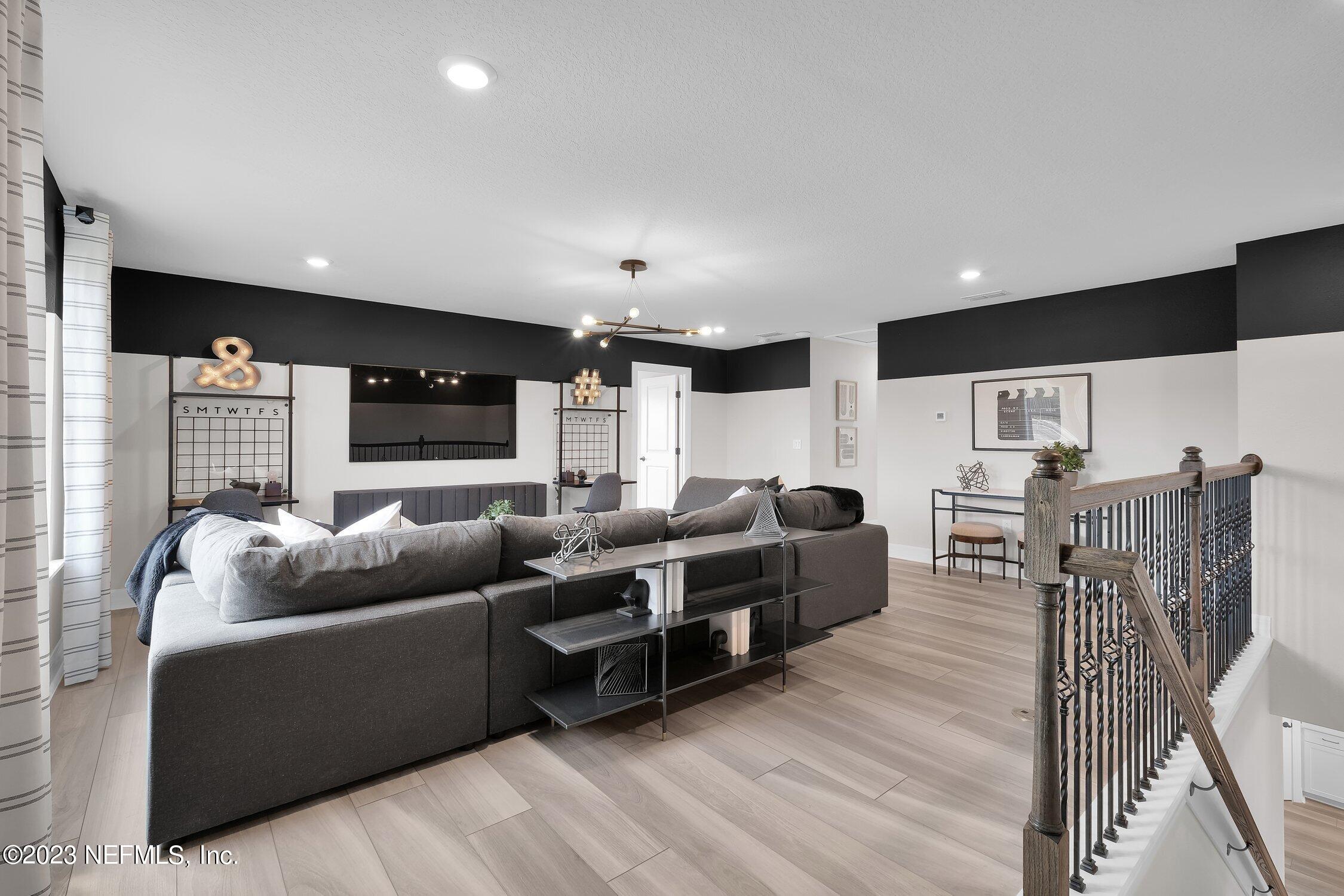 306 Shortleaf Lane Yulee, FL 32097 - Photo 22 of 35 a living room with furniture and a flat screen tv