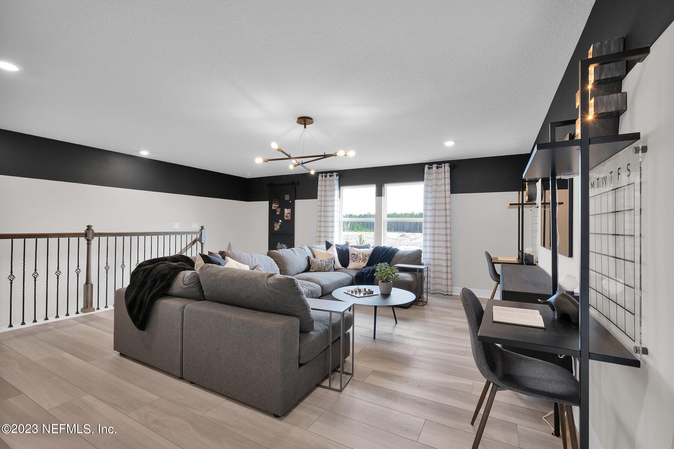 306 Shortleaf Lane Yulee, FL 32097 - Photo 23 of 35 a living room with furniture and a large window