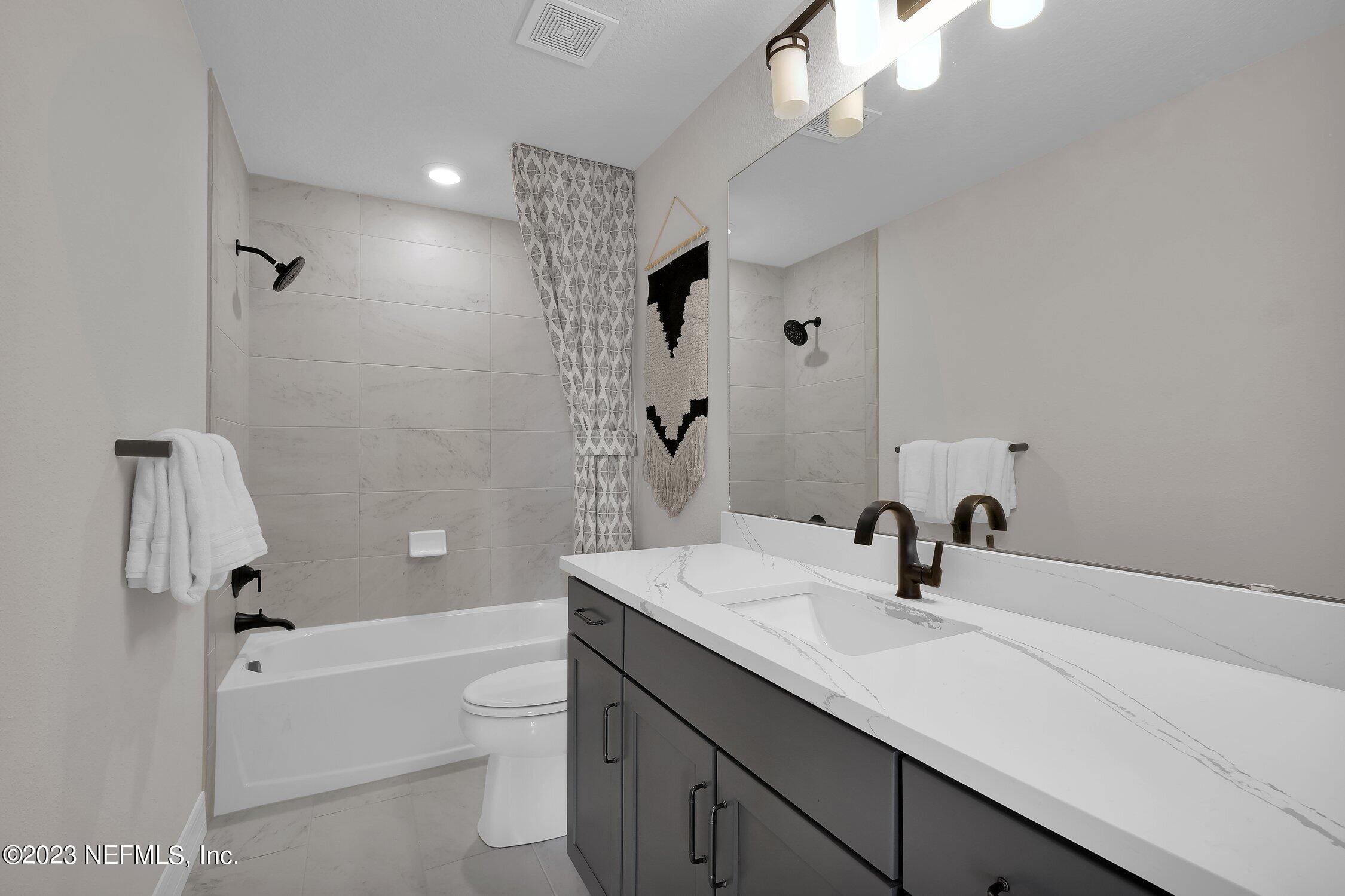306 Shortleaf Lane Yulee, FL 32097 - Photo 27 of 35 a bathroom with a sink a toilet and a bathtub