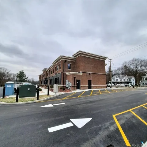 a front view of a house with a street