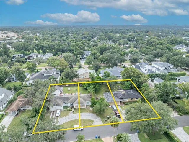 an aerial view of a residential houses with outdoor space