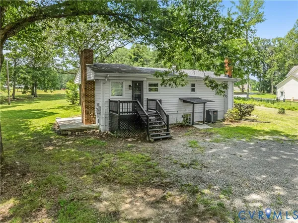 a view of a house with backyard porch and sitting area