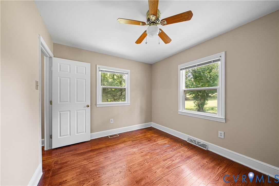 3179 Sandy Hook Road Sandy Hook, VA 23153 - Photo 16 of 36 wooden floor in an empty room with a window