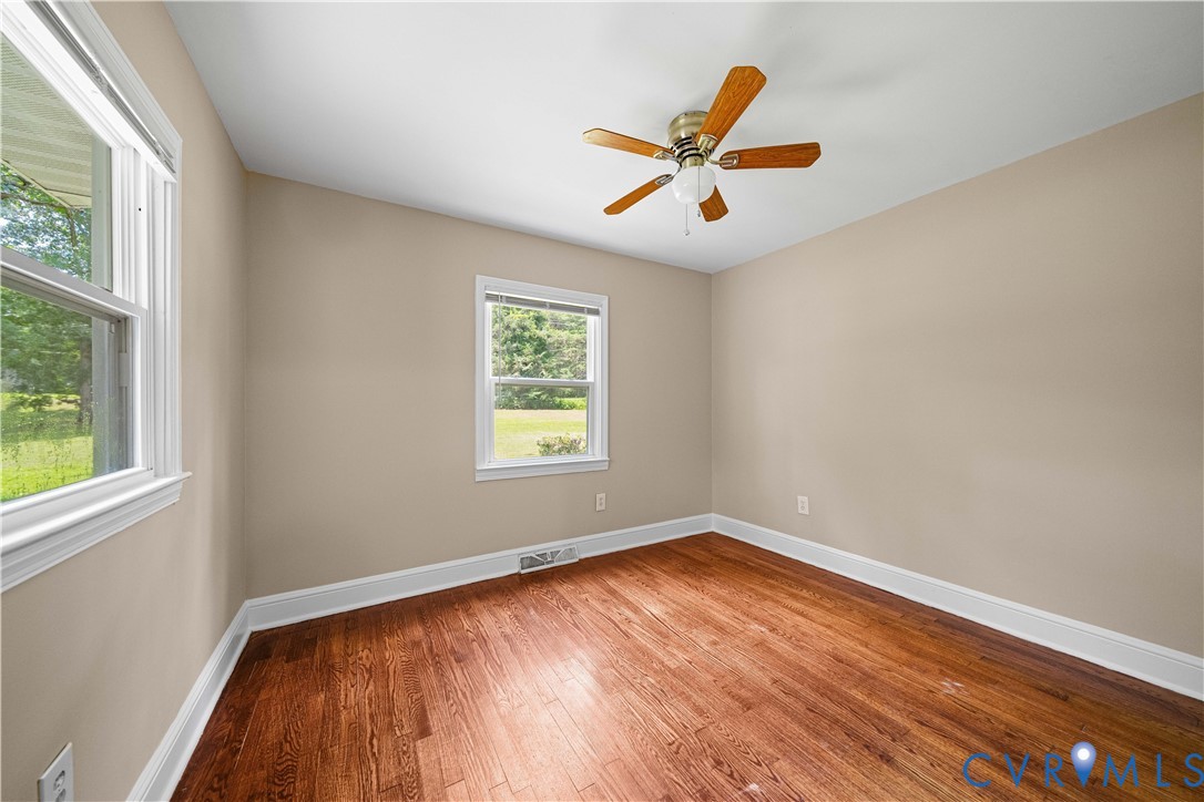 3179 Sandy Hook Road Sandy Hook, VA 23153 - Photo 18 of 36 a view of an empty room with window and wooden floor