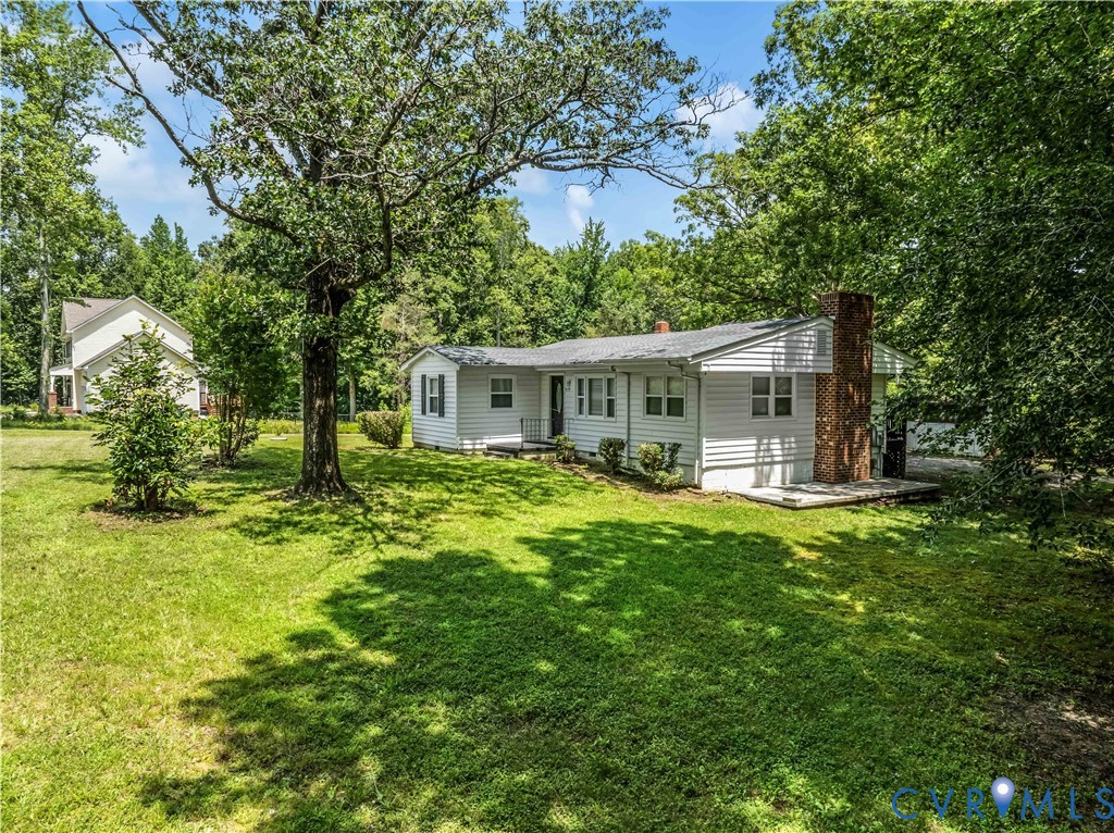 3179 Sandy Hook Road Sandy Hook, VA 23153 - Photo 2 of 36 a white house with a big yard plants and large trees