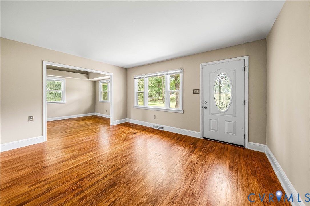 3179 Sandy Hook Road Sandy Hook, VA 23153 - Photo 26 of 36 an empty room with wooden floor and windows