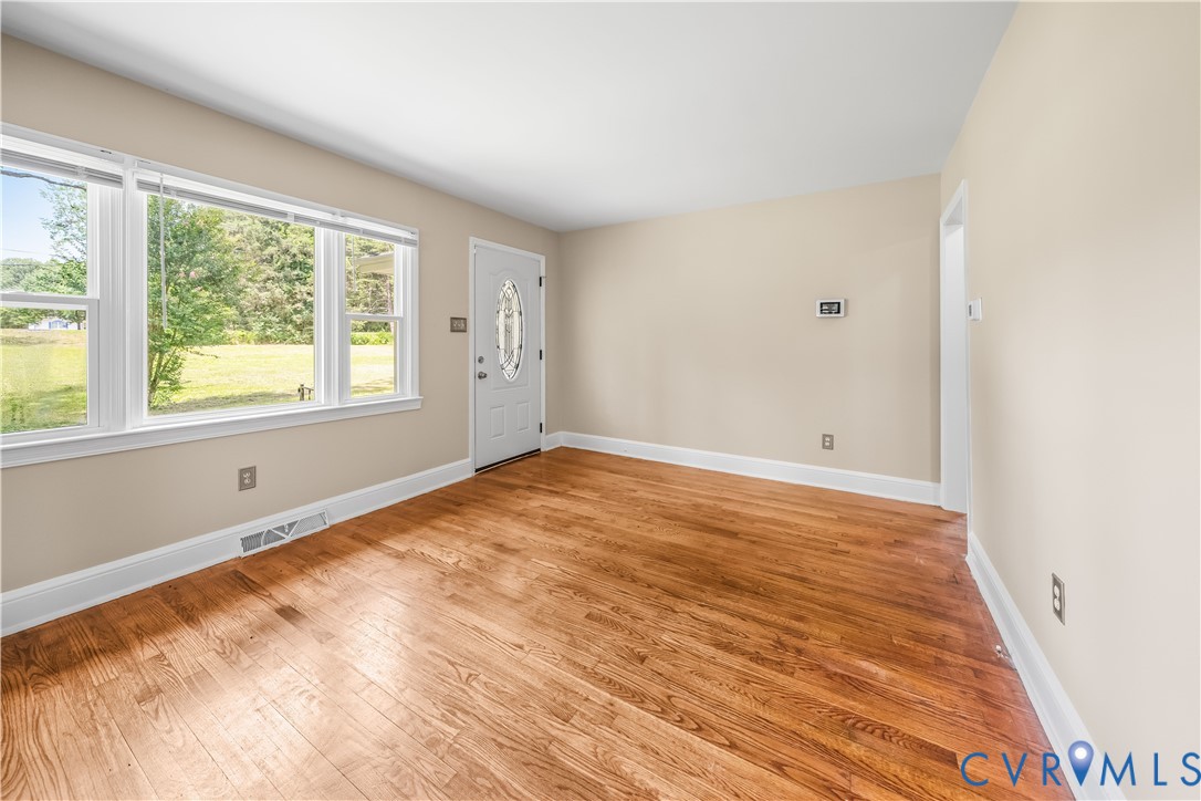 3179 Sandy Hook Road Sandy Hook, VA 23153 - Photo 27 of 36 a view of an empty room with wooden floor and a window