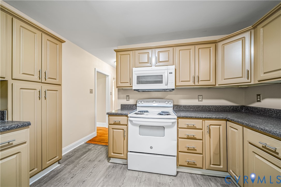 3179 Sandy Hook Road Sandy Hook, VA 23153 - Photo 28 of 36 a kitchen with white cabinets sink and stainless steel appliances