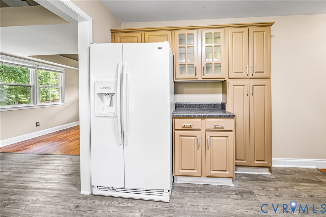 3179 Sandy Hook Road Sandy Hook, VA 23153 - Photo 31 of 36 a view of a kitchen with white cabinets and wooden floor