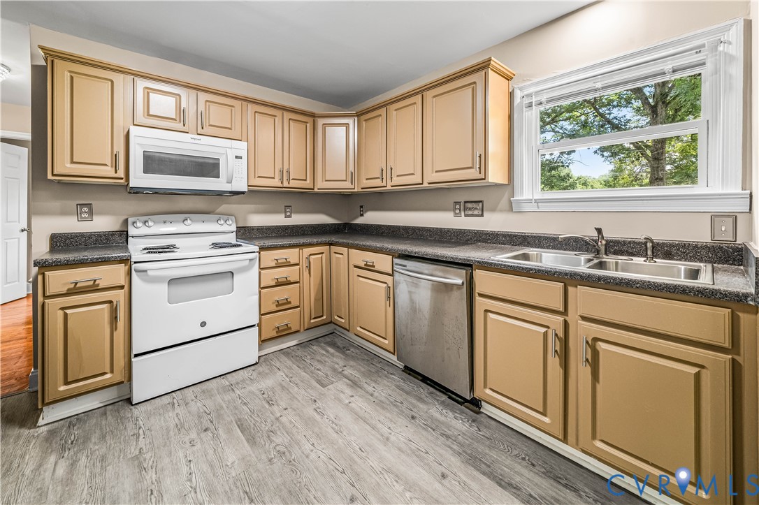 3179 Sandy Hook Road Sandy Hook, VA 23153 - Photo 32 of 36 a kitchen with white cabinets appliances a sink and a large window