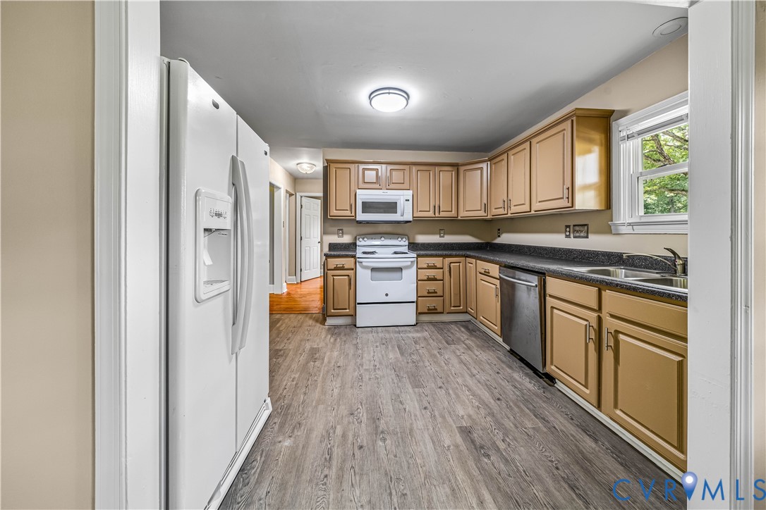 3179 Sandy Hook Road Sandy Hook, VA 23153 - Photo 33 of 36 a kitchen with stainless steel appliances granite countertop a stove and a refrigerator