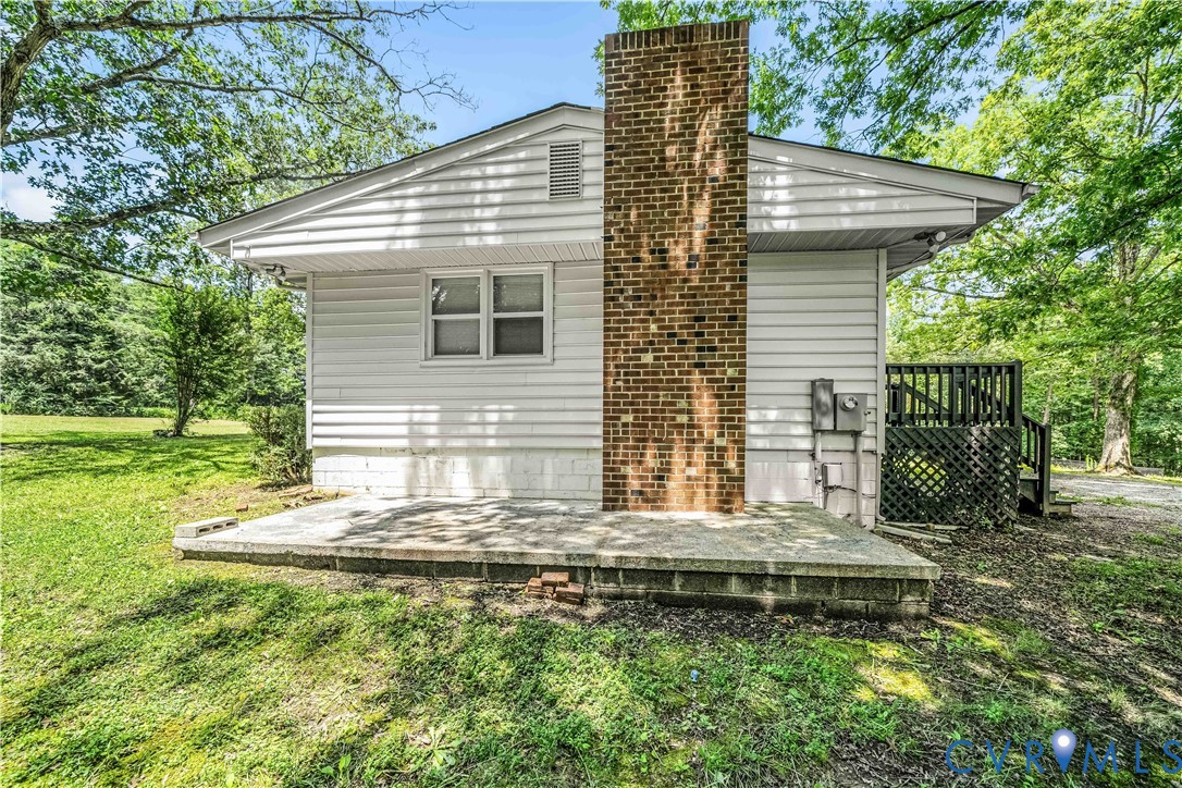 3179 Sandy Hook Road Sandy Hook, VA 23153 - Photo 10 of 36 a view of a house with backyard and garden