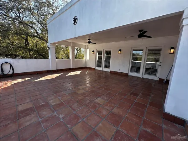 a view of a porch with wooden floor and fence