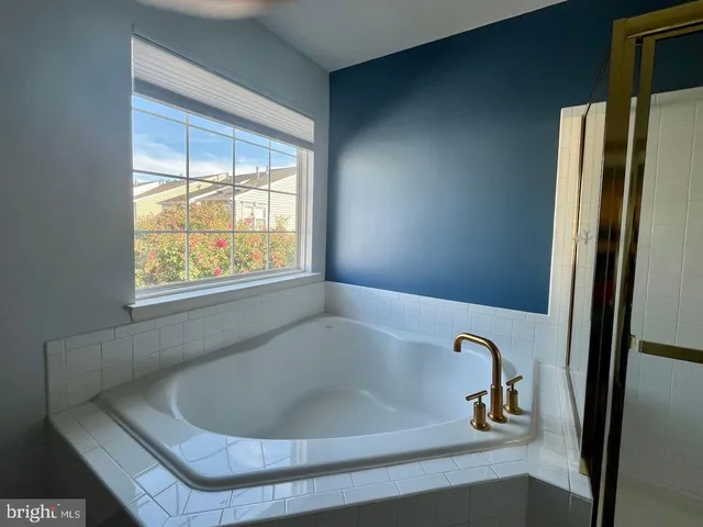 a bath tub sitting in a bathroom next to a window