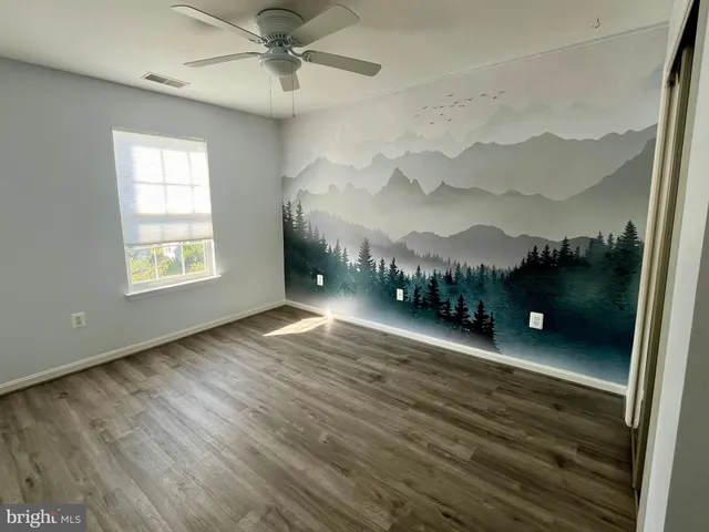 a view of a room with furniture and a window