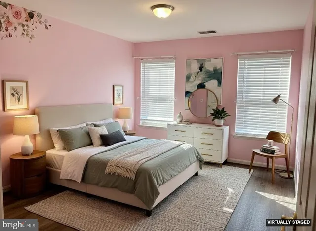 a bedroom with a bed and large windows