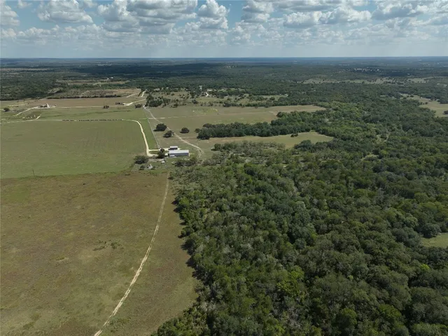 a view of a big yard with lots of green space