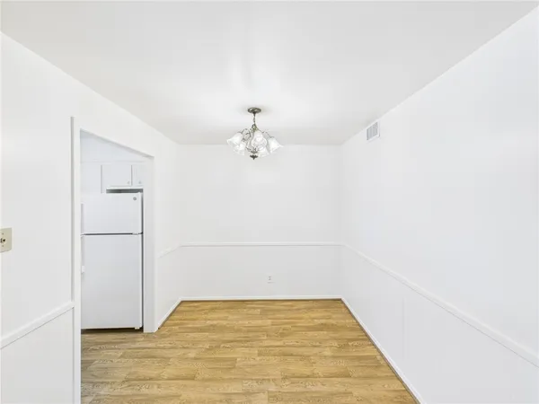 a view of a room with wooden floor